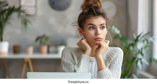 pensive young woman looking out the window