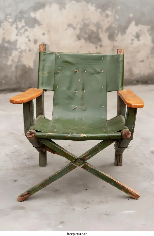 Green Wooden Folding Chair With Worn Canvas Seat
