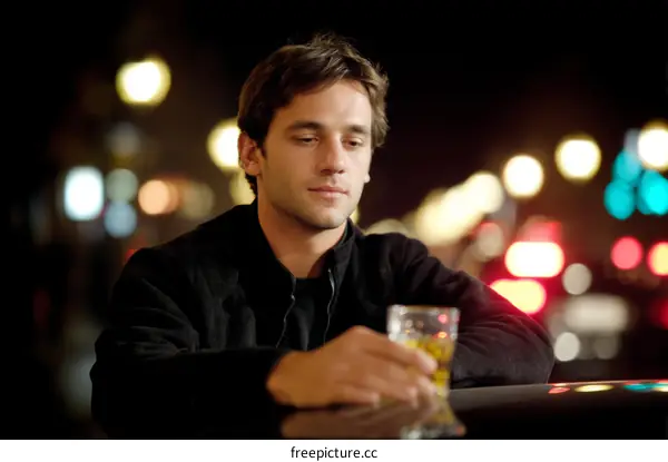Man with Drink at Night in City