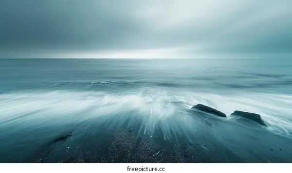 Black sand beach with soft wave and rock in Iceland