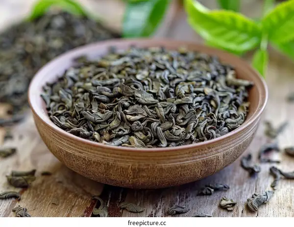 Green tea leaves in a ceramic bowl