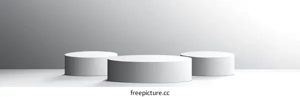 Three Minimalist White Cylindrical Display Stands