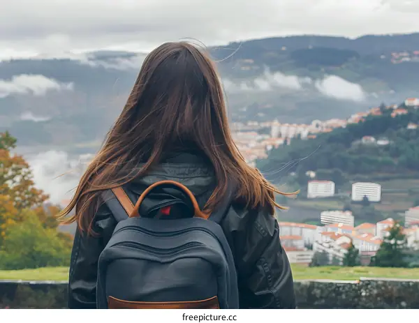 Woman with Backpack Looking at Mountain View