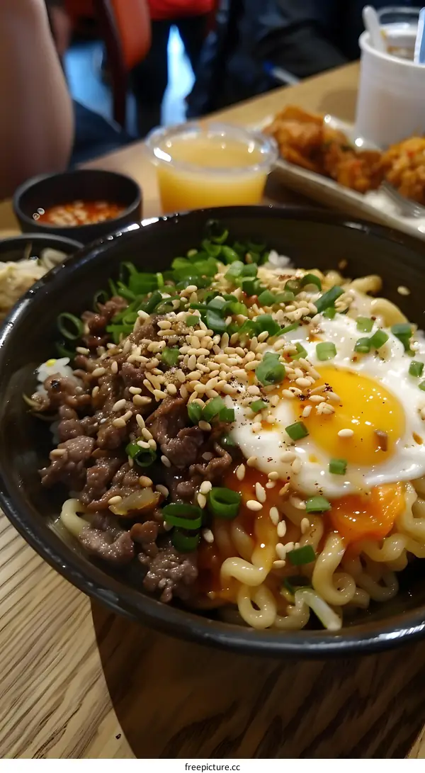 Korean spicy beef noodles with egg and sesame seeds