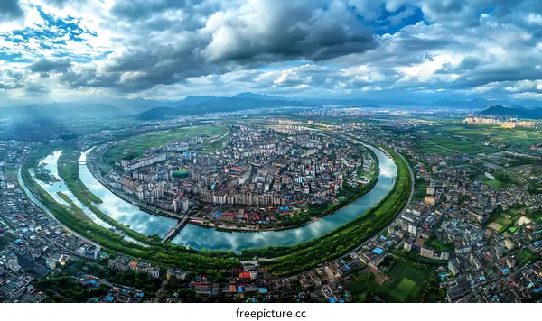 Aerial View of a City River Winding Through Urban Landscape