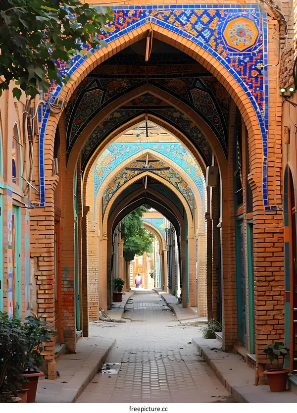 Long covered walkway with brick walls and arched openings