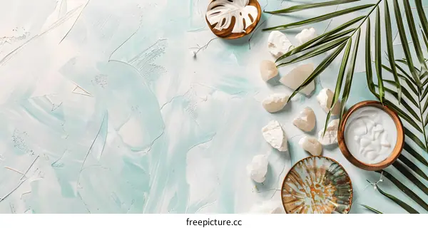 Blue and White Abstract Background with Palm Leaf, Stones, and Cream