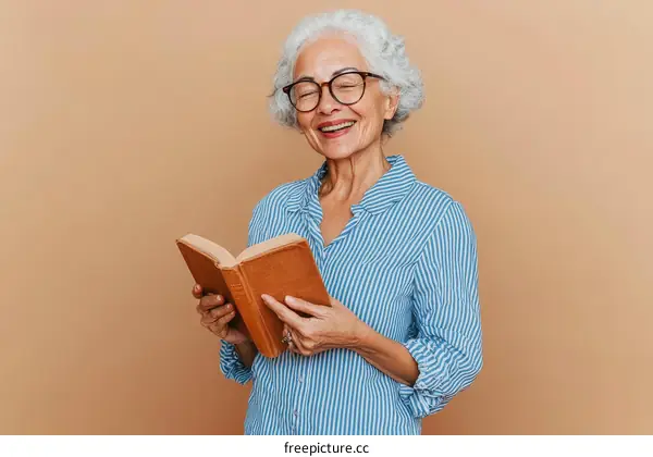Smiling Senior Woman Reading Book on Beige Background