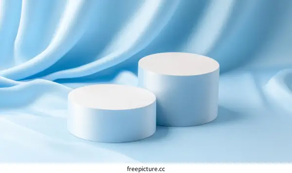 Light Blue Fabric Background with Cylindrical Display Platforms