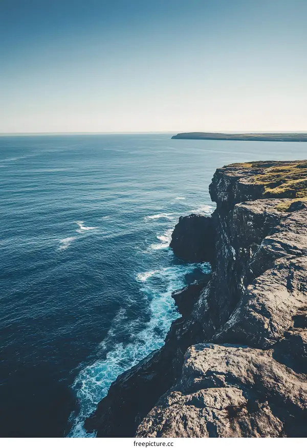 Cliffside View of the Ocean with Waves Crashing Against the Rocks