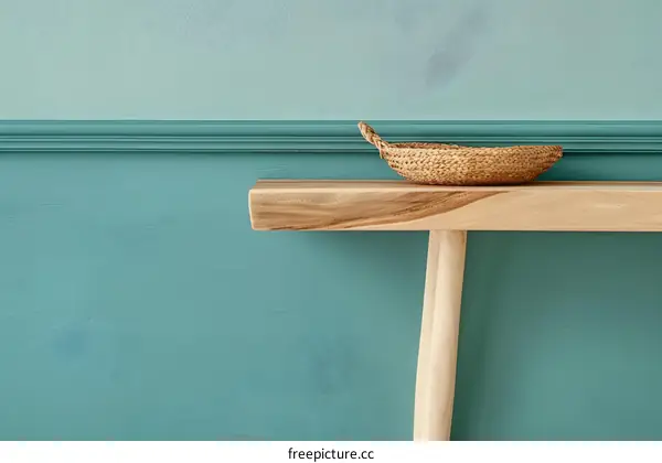 Wooden Console Table with Wicker Basket and Teal Wall
