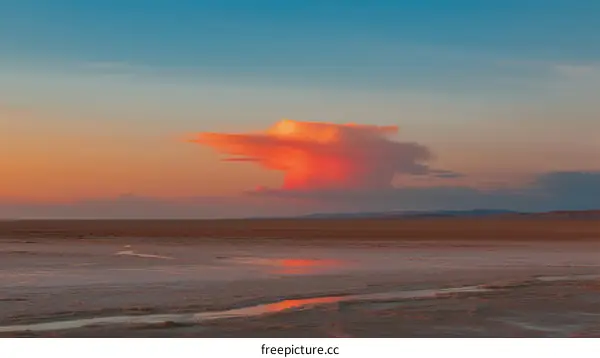 Vibrant Cloud at Sunset Over a Tranquil Landscape