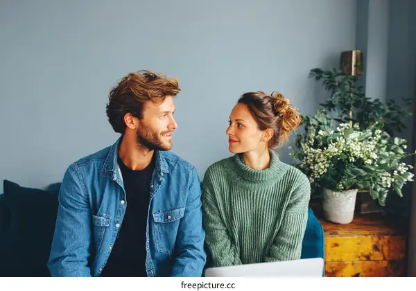 Couple Sitting and Looking at Each Other in a Cozy Home