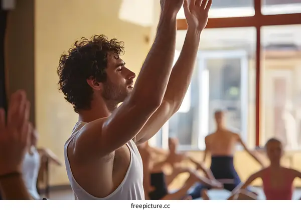 Man Stretching in Yoga Class with Other People
