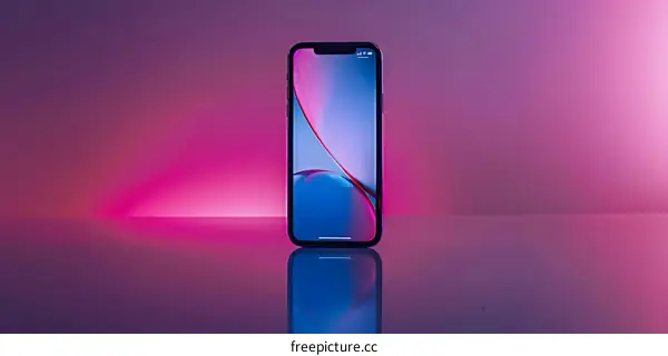 Smartphone with Blue and Pink Abstract Wallpaper on a Reflective Surface
