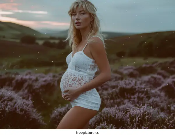 Portrait of a Pregnant Woman Standing in a Field of Purple Flowers