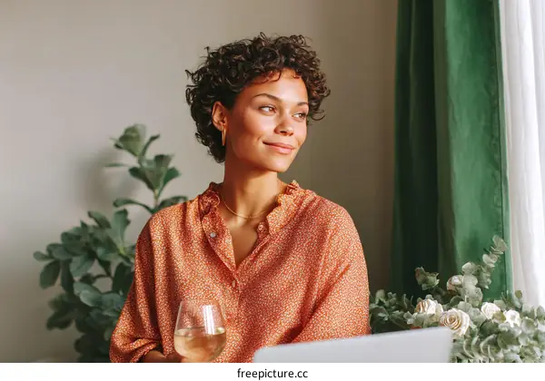 Woman Relaxing with Wine and Laptop