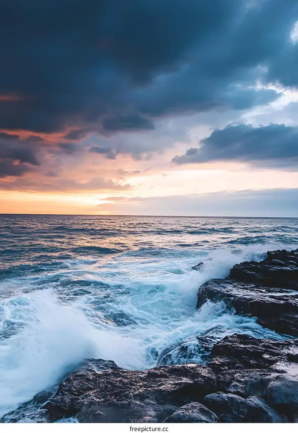 Ocean Waves Crashing On Rocky Shore At Sunset
