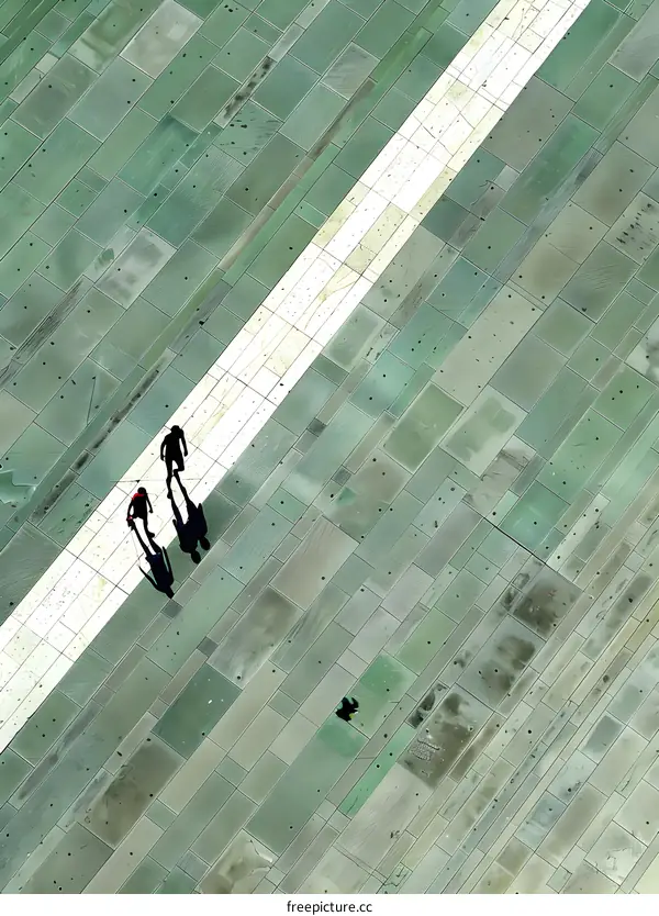 Aerial View of People Walking on a Patterned Pavement