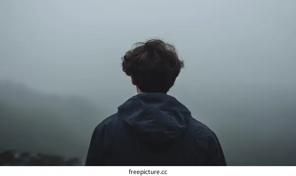Man standing alone in the mist