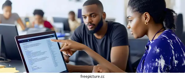 Two African American People Working on Project In Office