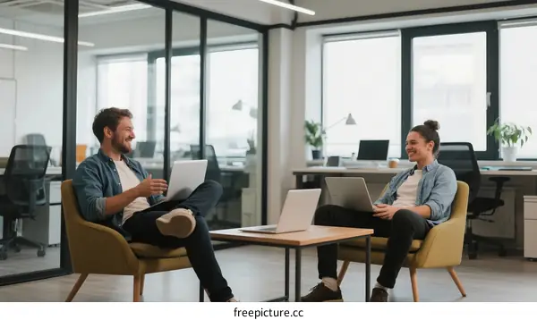 Two colleagues having a conversation in a modern office space