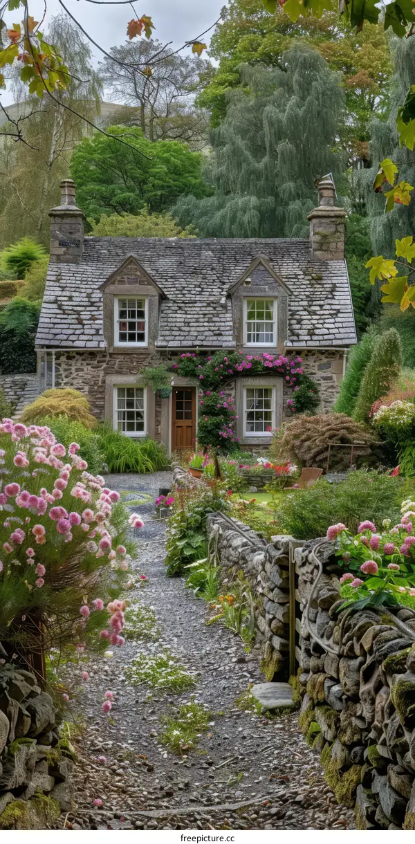 Stone cottage in the countryside surrounded by trees and flowers