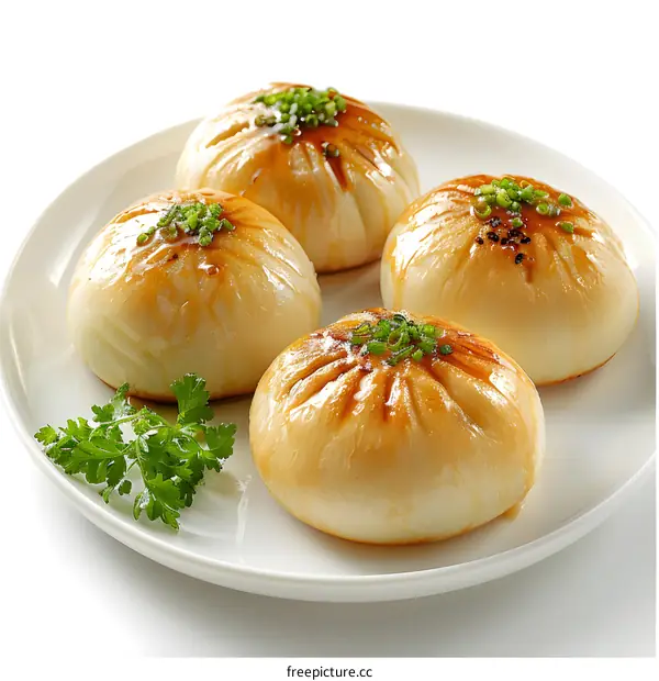 Steamed buns on a white plate