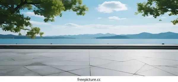 A serene view of a lake with clear sky and trees around