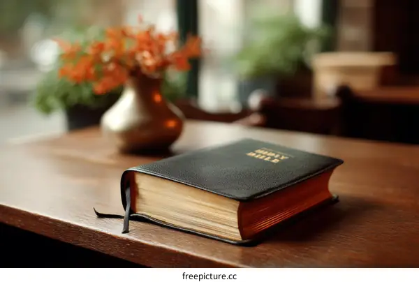 Holy Bible on a Wooden Table with Vase