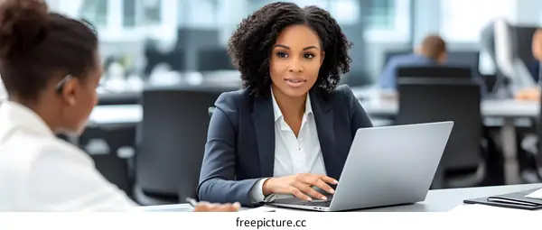 African American Businesswoman Working on Laptop in Modern Office
