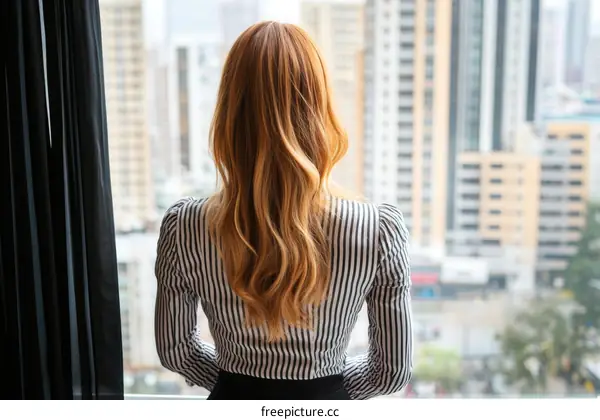Woman Contemplating Cityscape through Window