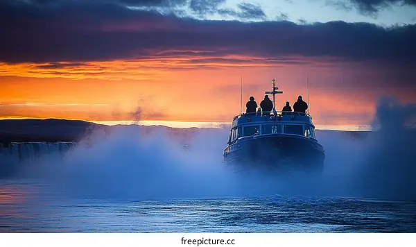 Sunrise over a boat crossing a frozen waterfall