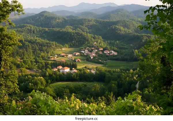 Aerial View of a Small Village Nestled Among Lush Green Hills