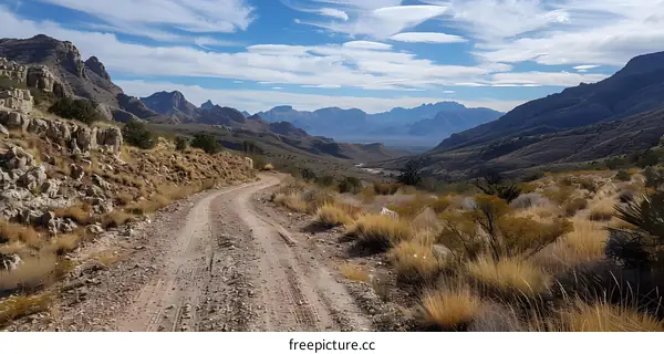 Dirt Road Leading Through Mountain Valley