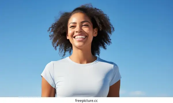 Smiling woman with curly hair looking up at the sky