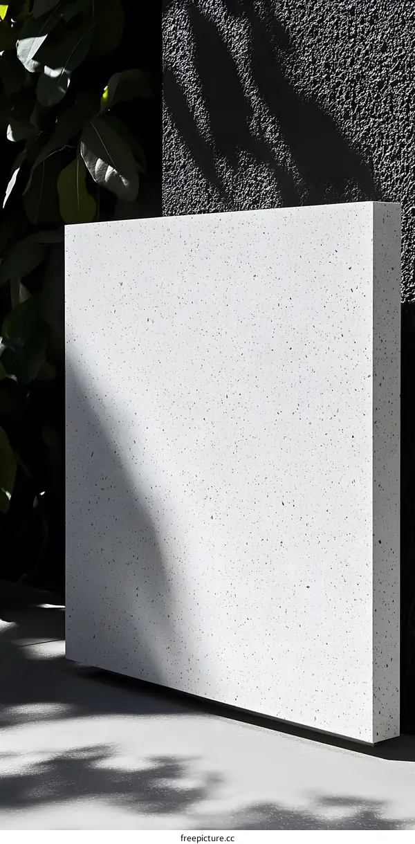 White Concrete Wall With Speckled Texture And Shadows