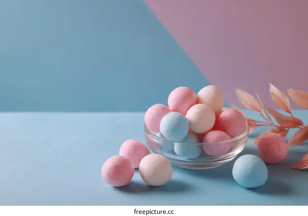 Colorful Candies in Glass Bowl on Pastel Background