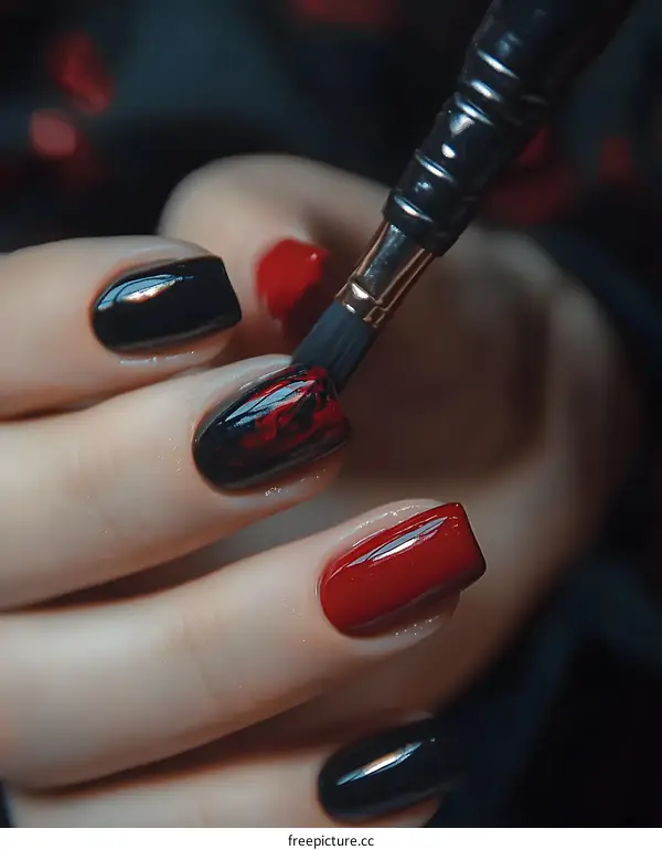 Close Up Of Woman Hands with Red and Black Nail Polish