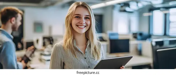 Smiling Woman Holding Tablet in Modern Office