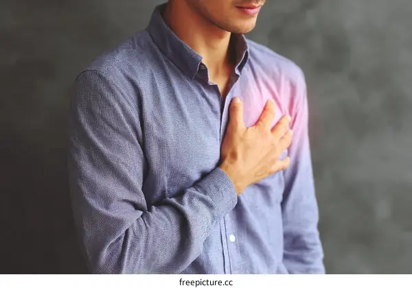 Man experiencing chest pain with hand on chest area