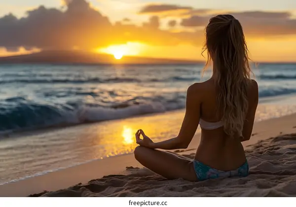 Woman Meditating On Beach at Sunset