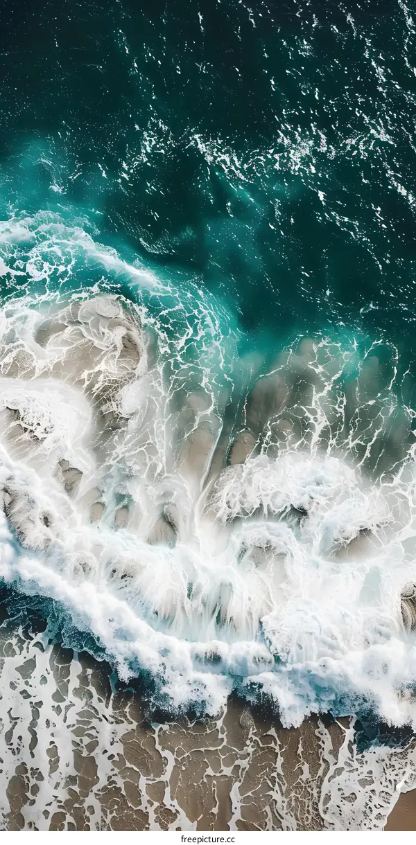 Aerial View of Ocean Waves Crashing on Sandy Beach