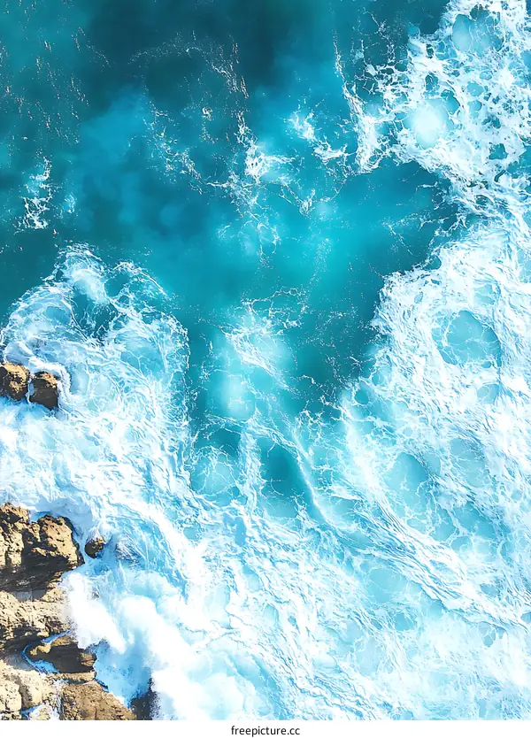 Aerial View of Ocean Waves Crashing on Rocks