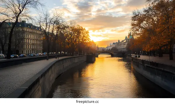 Sunset View of a City with a River and Bridge