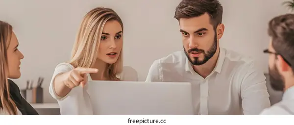 Young Business Team Discussing Ideas and Project on Laptop