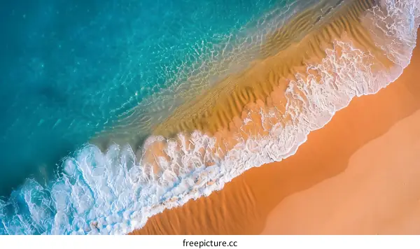 Aerial View of Ocean Waves Crashing on Sandy Beach