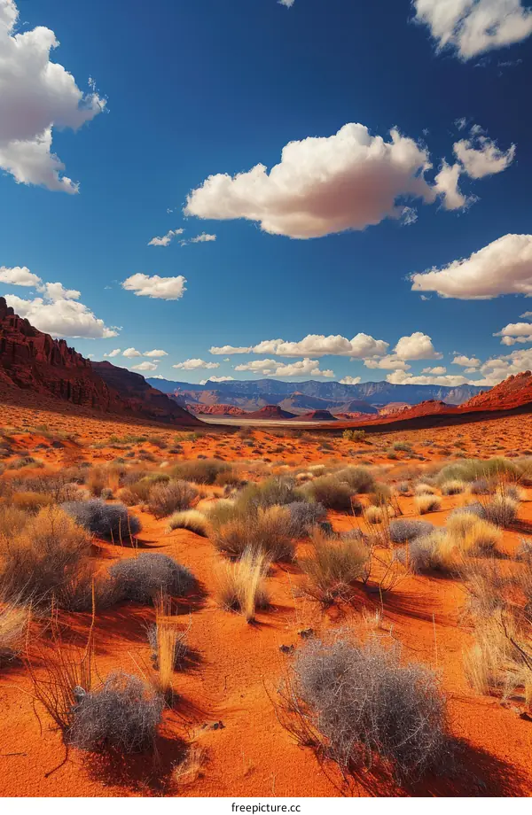 Arid Desert Landscape with Red Rock Formations and Blue Sky