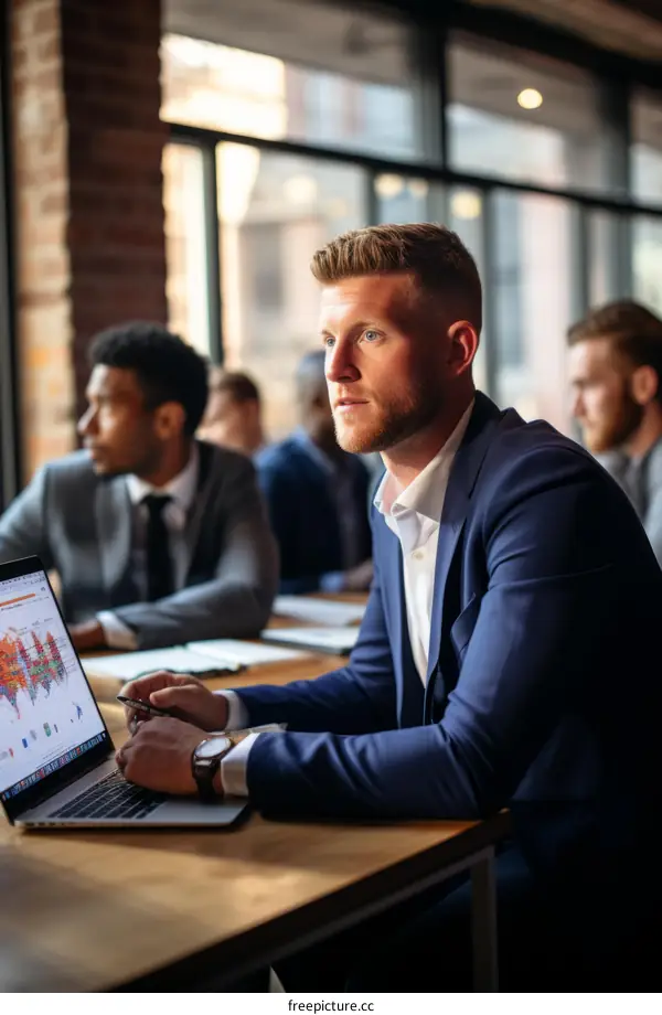Business meeting discussing financial data on laptop