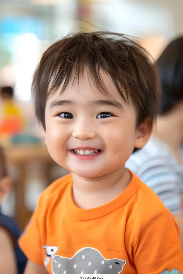 Smiling Asian Child in Orange Shirt